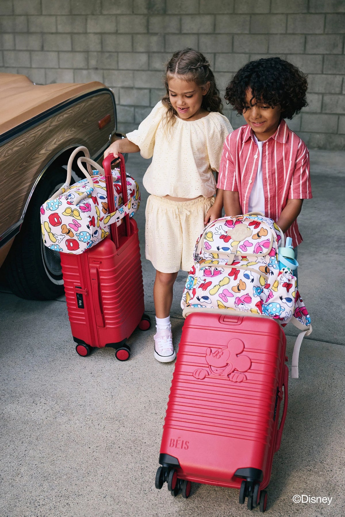 The Disney Small Carry-On Roller  in Mickey Mouse Red